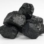 Few pieces of charcoal on white background